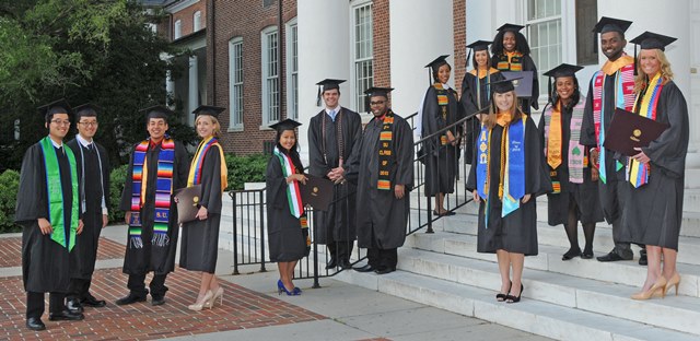 Graduates in front of Holloway Hall